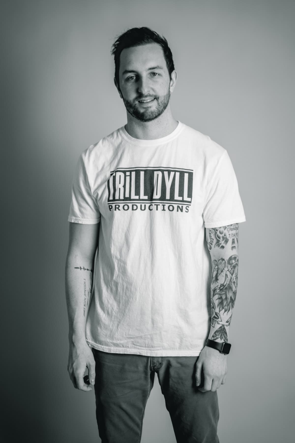 Black-and-white portrait of Dylan in a TRiLL DYLL Productions t-shirt